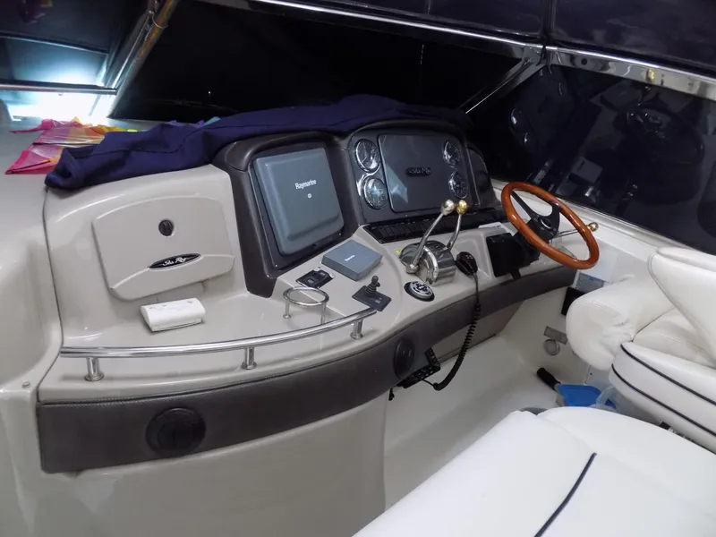 Slide: The Image of Helm of 2006 Sea Ray 44 Sundancer with navigation equipment and wooden steering wheel. - 45