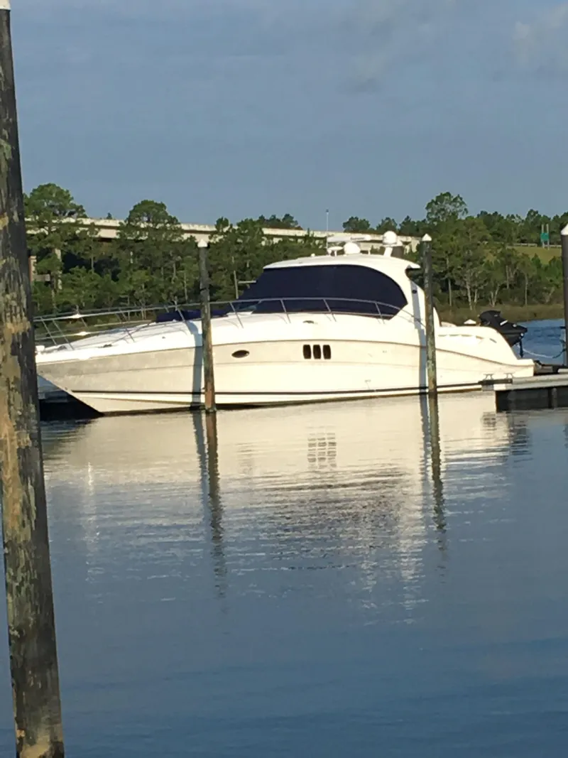 Slide: The Image of 2006 Sea Ray 44 Sundancer yacht docked on calm water. - 7