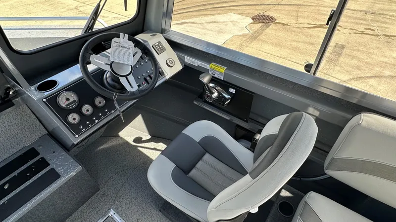Slide: The Image of Interior of 2025 Spartan 215 Athens boat, featuring modern steering and controls. - 5