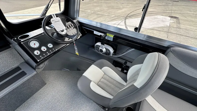 Slide: The Image of 2024 Spartan 200 Astoria boat interior with steering wheel and control panel. - 3