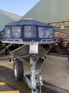 Slide: The Image of 2024 Spartan 200 Astoria boat on trailer, displayed outdoors. - 38