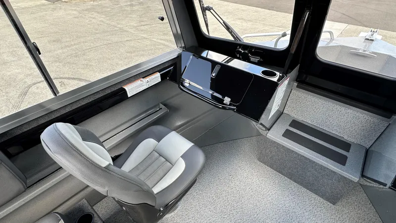 Slide: The Image of 2024 Spartan 200 Astoria boat interior with modern helm and comfortable seating. - 5