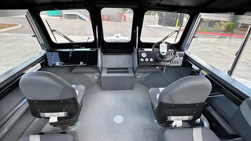 Slide: The Image of 2024 Spartan 200 Astoria boat interior with dual seats and modern dashboard. - 6