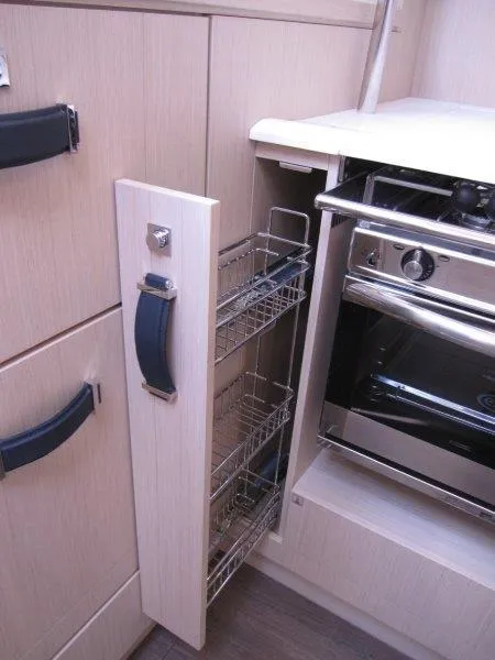 Slide: The Image of 2024 Jeanneau 60 yacht kitchen with pull-out storage and modern oven. - 15