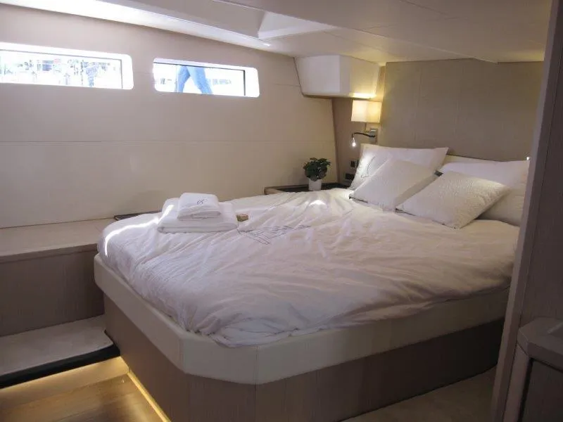 Slide: The Image of Luxurious bedroom interior of 2024 Jeanneau 60 yacht with modern design and cozy bedding. - 2