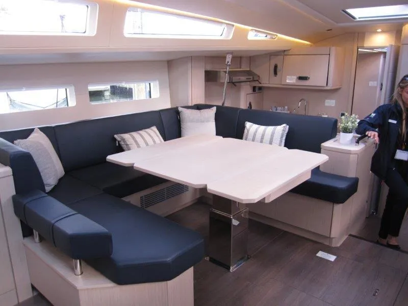 Slide: The Image of Modern interior of 2024 Jeanneau 60 yacht with spacious seating and dining area. - 3