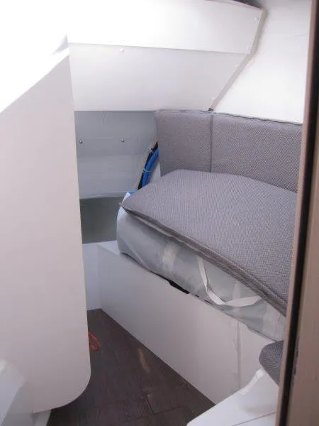 Slide: The Image of 2024 Jeanneau 60 yacht interior cabin with grey cushions. - 34