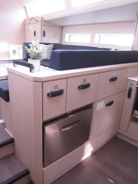 Slide: The Image of 2024 Jeanneau 60 yacht interior with modern kitchen and seating area. - 11