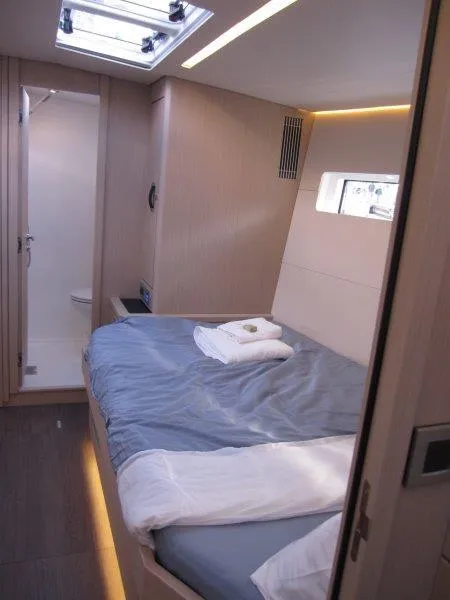 Slide: The Image of Modern cabin interior of 2024 Jeanneau 60 yacht with bed and ensuite bathroom. - 28