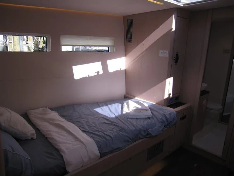 Slide: The Image of 2024 Jeanneau 60 yacht interior cabin with bed and window. - 32