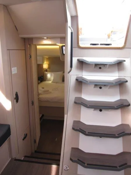 Slide: The Image of Interior of 2024 Jeanneau 60 yacht showing stairs and cozy bedroom. - 37