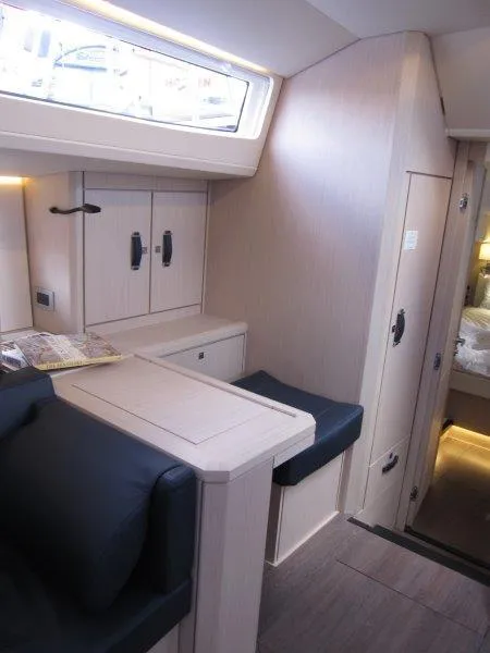 Slide: The Image of Interior of 2024 Jeanneau 60 yacht with modern furnishings and ample natural light. - 7