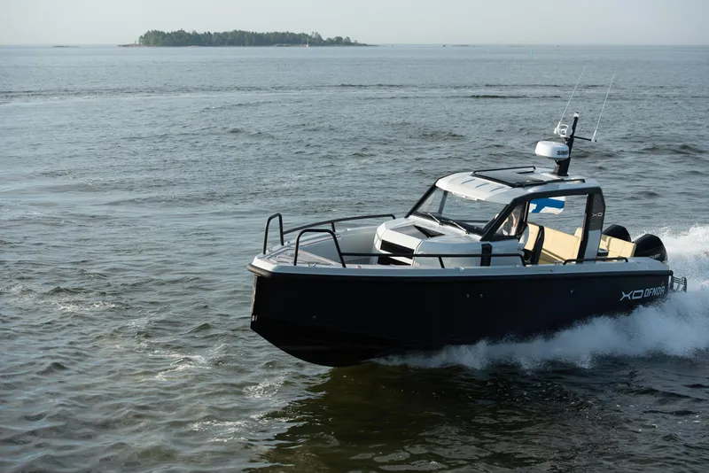 Slide: The Image of 2023 XO Boats Defender 9 cruising on open water. - 10