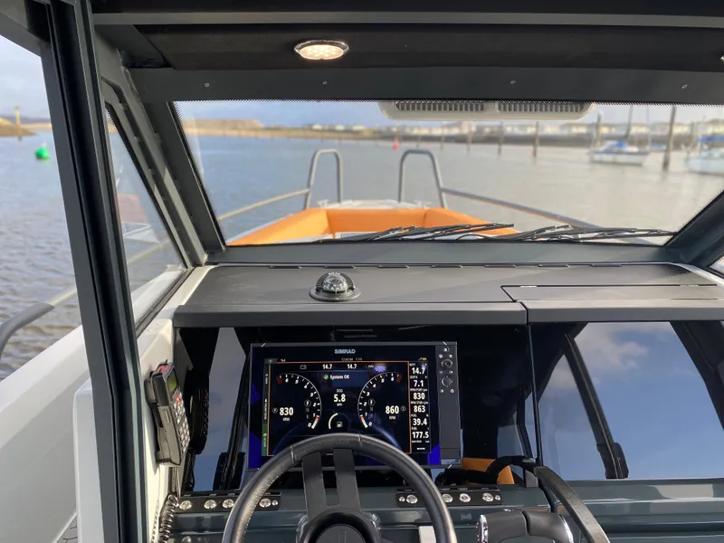 Slide: The Image of Cockpit view of 2023 XO Boats Defender 9 with advanced navigation system. - 12