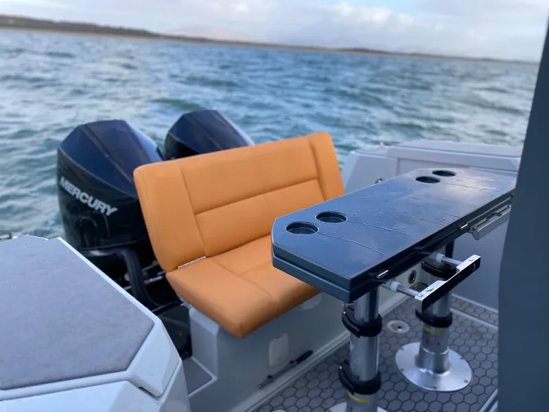 Slide: The Image of 2023 XO Boats Defender 9 with dual Mercury engines and orange seating. - 16