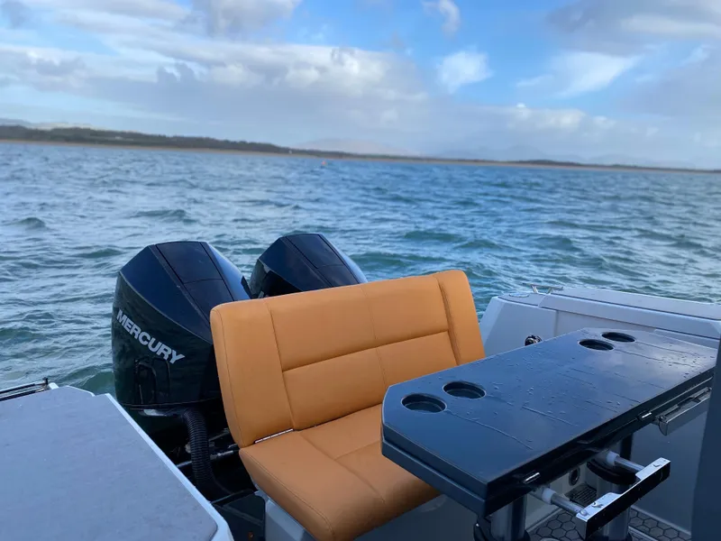 Slide: The Image of XO Boats Defender 9 (2023) with Mercury engines on a scenic water backdrop. - 17