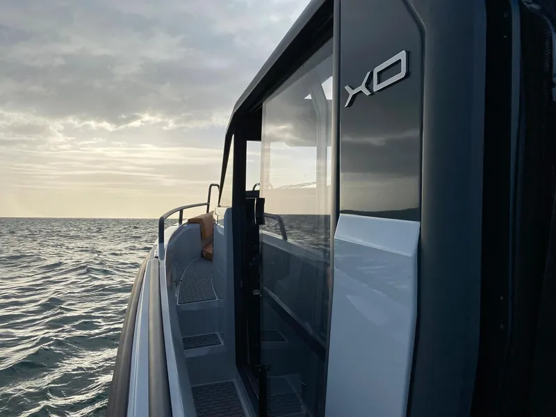 Slide: The Image of 2023 XO Boats Defender 9 on the water at sunset. - 19