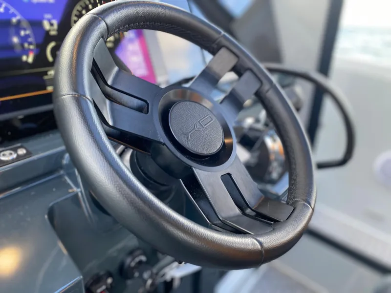 Slide: The Image of Steering wheel of 2023 XO Boats Defender 9 with dashboard in background. - 22