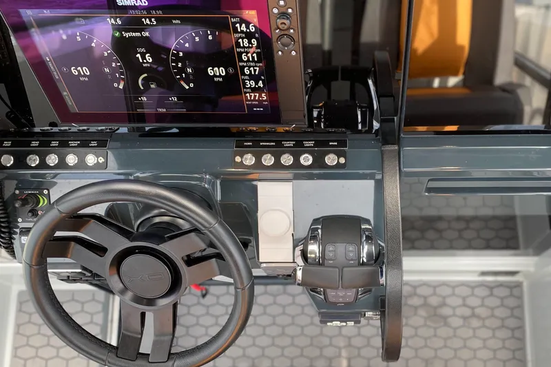 Slide: The Image of Dashboard of 2023 XO Boats Defender 9 with steering wheel and control panel. - 23