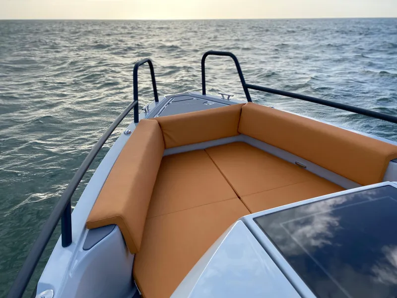 Slide: The Image of 2023 XO Boats Defender 9 with orange seating on open water. - 25