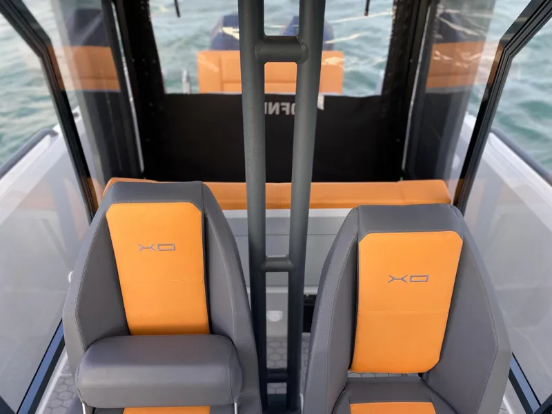 Slide: The Image of 2023 XO Boats Defender 9 interior with orange and gray seats. - 27