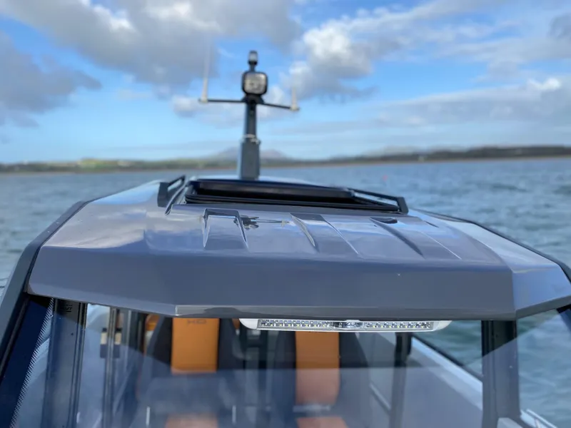 Slide: The Image of 2023 XO Boats Defender 9 on water with radar and clear sky. - 28