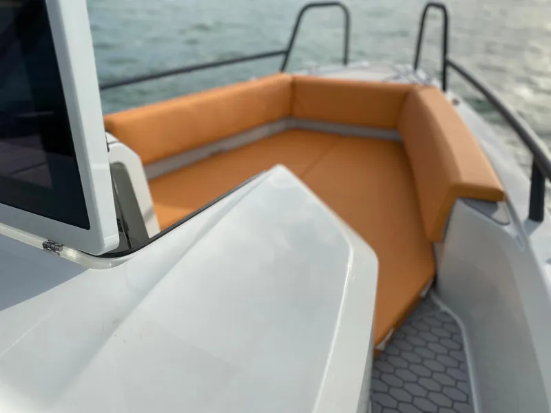 Slide: The Image of 2023 XO Boats Defender 9 with orange seating on deck. - 32
