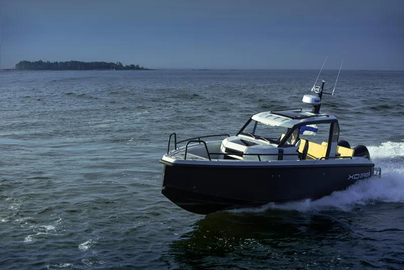 Slide: The Image of 2023 XO Boats Defender 9 cruising on open water. - 4