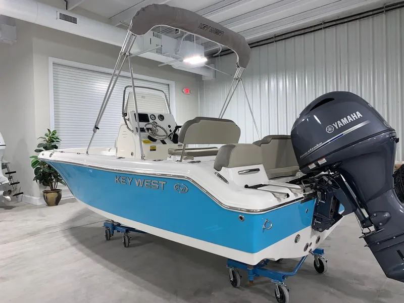 Slide: The Image of 2024 Key West 189 FS boat with Yamaha outboard motor in indoor showroom. - 1