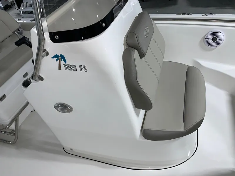 Slide: The Image of 2024 Key West 189 FS boat interior with cushioned seating and console. - 13