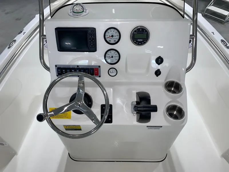 Slide: The Image of 2024 Key West 189 FS boat console with steering wheel, gauges, and controls. - 6