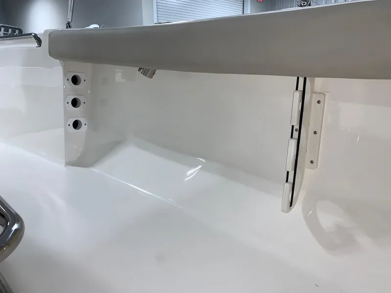 Slide: The Image of 2024 Key West 189 FS boat interior detail showing rod holders and storage compartment. - 15