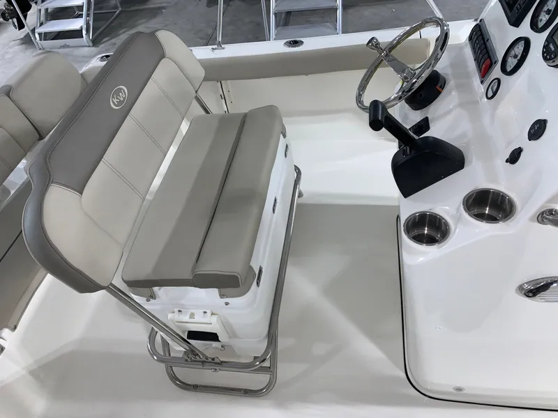 Slide: The Image of 2024 Key West 189 FS boat interior with steering wheel and cushioned seating. - 5