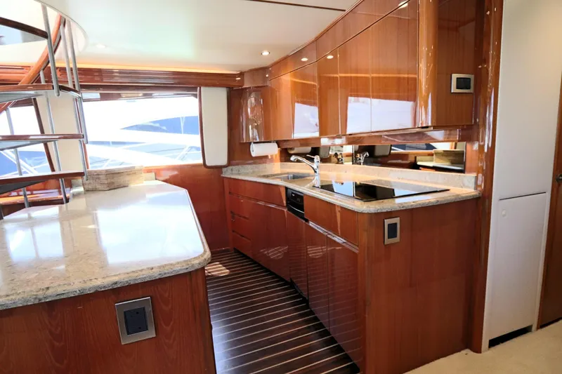 Slide: The Image of Luxurious kitchen interior of 2013 Viking 66 yacht with sleek wood finishes and modern appliances. - 13