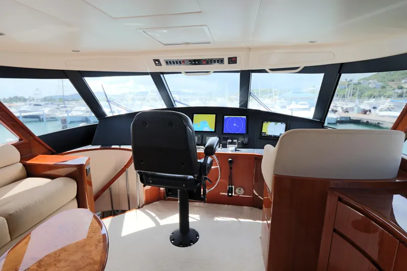 Slide: The Image of Interior of a 2013 Viking 66 yacht cockpit with navigation equipment and panoramic windows. - 16