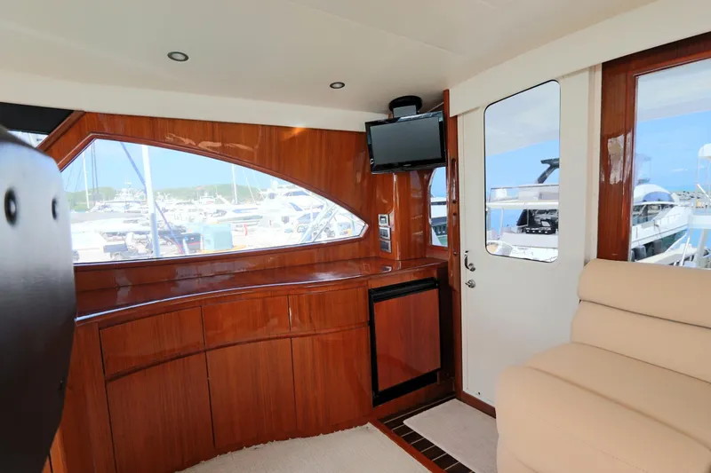Slide: The Image of Luxurious interior of 2013 Viking 66 yacht with wood paneling and marina view. - 17