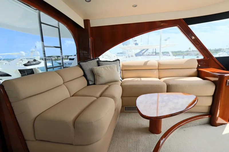 Slide: The Image of Luxurious interior of 2013 Viking 66 yacht with beige seating and wooden accents. - 18