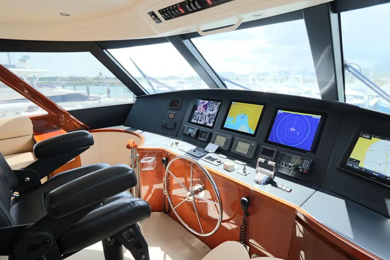 Slide: The Image of Cockpit of 2013 Viking 66 yacht with advanced navigation systems and luxurious seating. - 19