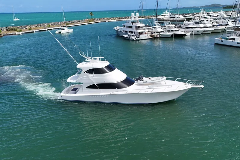 Slide: The Image of Luxury 2013 Viking 66 yacht cruising in a marina with clear blue waters. - 2