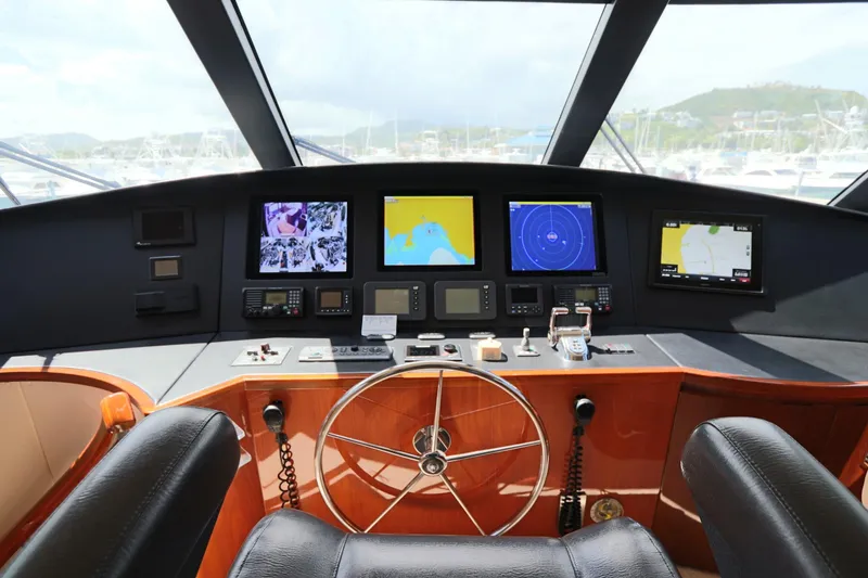 Slide: The Image of Cockpit of 2013 Viking 66 yacht with navigation screens and steering wheel. - 21