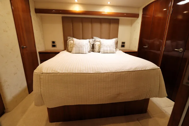 Slide: The Image of Luxurious bedroom interior of 2013 Viking 66 yacht with elegant bedding and wooden cabinetry. - 26