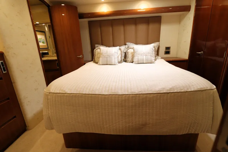 Slide: The Image of Luxurious bedroom interior of 2013 Viking 66 yacht with elegant bedding and wood accents. - 27