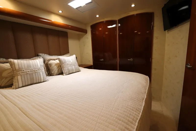 Slide: The Image of Luxurious bedroom interior of 2013 Viking 66 yacht with elegant bedding and wooden accents. - 28