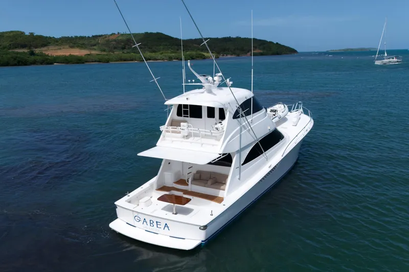 Slide: The Image of 2013 Viking 66 yacht cruising in clear blue waters. - 3