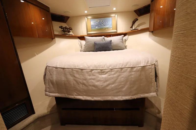 Slide: The Image of Luxurious bedroom interior of 2013 Viking 66 yacht with elegant bedding and wooden cabinetry. - 33