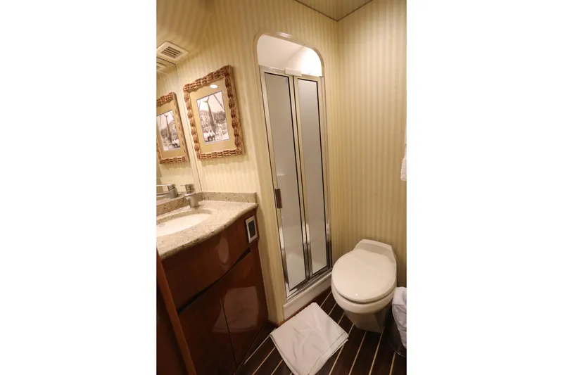 Slide: The Image of Luxurious bathroom in 2013 Viking 66 yacht with shower, toilet, and vanity. - 37