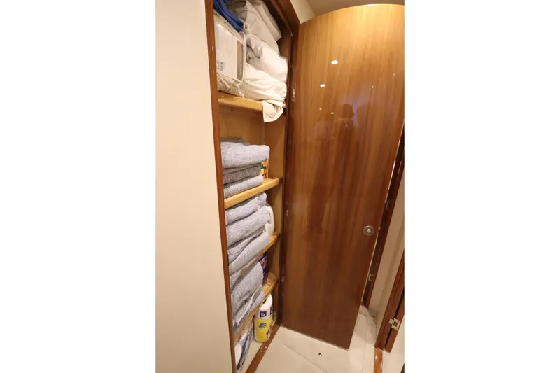 Slide: The Image of Storage closet with neatly stacked towels and supplies on a Viking 66 yacht, 2013 model. - 38