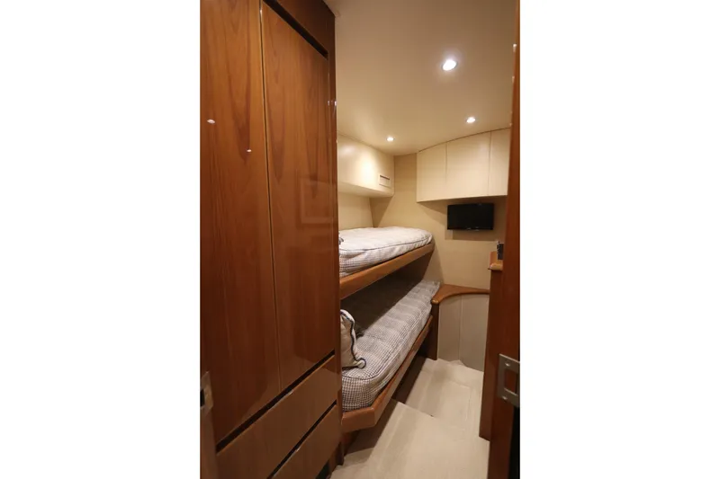 Slide: The Image of Cozy cabin interior of 2013 Viking 66 yacht with bunk beds and wooden finishes. - 39