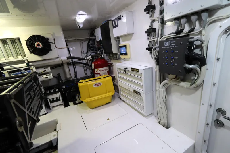 Slide: The Image of Engine room of 2013 Viking 66 yacht with equipment and storage units. - 49