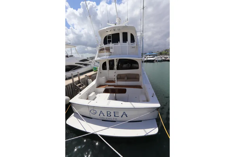 Slide: The Image of 2013 Viking 66 yacht docked in marina, rear view with clear skies. - 51